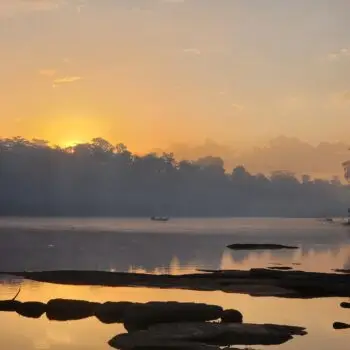 The view I would have missed if I didn't overcome my fear as a writer: the sun rising over the rainforest and the Suriname river wit a few rocks in the forefront